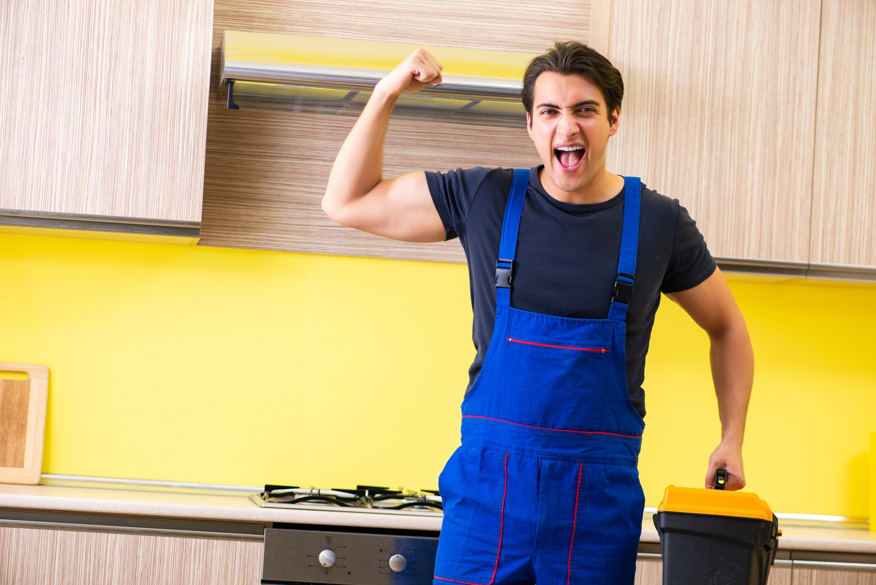 Young Service Contractor Assembling Kitchen Furniture