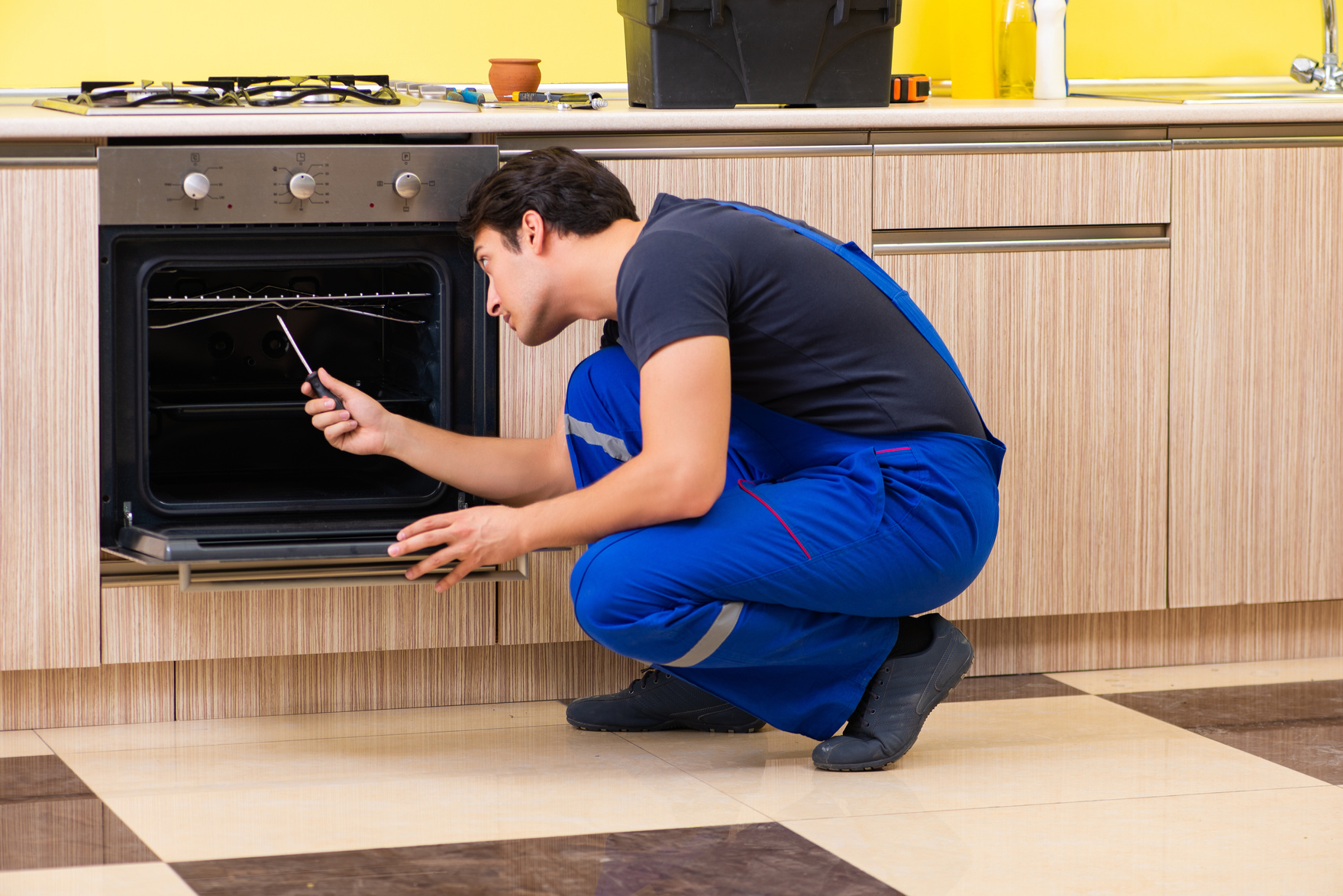 Young Service Contractor Assembling Kitchen Furniture